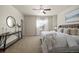 Elegant bedroom with large windows, stylish furniture, and a king-sized bed at 3880 E 128Th Way, Thornton, CO 80241