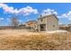 View of the spacious backyard featuring a covered patio and house exterior at 7768 Xavier Ct, Westminster, CO 80030