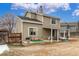 The exterior backyard showcases a home with a covered patio and a yard with partial snow cover at 7768 Xavier Ct, Westminster, CO 80030