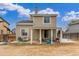 An exterior backyard view displays a home with a covered patio and a partially snow-covered lawn at 7768 Xavier Ct, Westminster, CO 80030