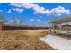 The exterior backyard shows a spacious grassy area, a covered patio, and a surrounding wooden fence at 7768 Xavier Ct, Westminster, CO 80030