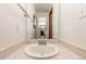 Bathroom featuring a single sink, neutral countertops, a large mirror, and wood trim at 7768 Xavier Ct, Westminster, CO 80030
