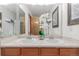 Bathroom featuring double sinks, framed mirror, and wood cabinetry at 7768 Xavier Ct, Westminster, CO 80030