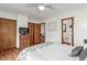 Bedroom features hardwood floors, a ceiling fan, a dresser, closets, and an open bathroom at 7768 Xavier Ct, Westminster, CO 80030