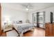 Bedroom features hardwood floors, a ceiling fan, and a window for natural light at 7768 Xavier Ct, Westminster, CO 80030