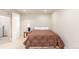 A cozy bedroom with a patterned bedspread, side table and lamp provides a comfortable retreat at 7768 Xavier Ct, Westminster, CO 80030