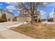 Two-story house with a two-car garage and a well-manicured lawn, complemented by mature trees and landscaping at 7768 Xavier Ct, Westminster, CO 80030