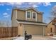 Two-story home with a two-car garage, featuring a well-kept lawn and decorative mailbox, enhanced by a partly cloudy sky at 7768 Xavier Ct, Westminster, CO 80030