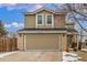 Charming two-story home with a two-car garage and well-lit exterior, set against a backdrop of a bright sky at 7768 Xavier Ct, Westminster, CO 80030