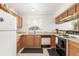 Functional kitchen with wood cabinets, laminate countertops, white appliances, and a window over the sink at 7768 Xavier Ct, Westminster, CO 80030