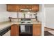 Kitchen features wood cabinets, laminate countertops, white appliances, and an electric range at 7768 Xavier Ct, Westminster, CO 80030