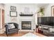 Cozy living room featuring a fireplace, stylish decor, and comfortable seating, perfect for relaxation and entertaining at 7768 Xavier Ct, Westminster, CO 80030