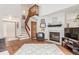 Spacious living area with a fireplace, staircase, and wood-look flooring, providing a warm and inviting atmosphere at 7768 Xavier Ct, Westminster, CO 80030