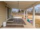 A covered patio features brick flooring, an outdoor seating area, and a view of the backyard at 7768 Xavier Ct, Westminster, CO 80030
