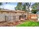 A spacious backyard with a wood fence and a chicken coop at 1548 Ulster St, Denver, CO 80220