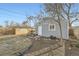 Backyard shed on a yard with a small fence and fire pit on a sunny day at 1548 Ulster St, Denver, CO 80220