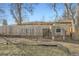 The backyard of this home features a wooden fence and a chicken coop at 1548 Ulster St, Denver, CO 80220