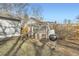 Backyard with grill and utility structure with access window on a sunny day at 1548 Ulster St, Denver, CO 80220
