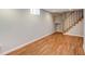 Finished basement with wood floors and access to staircase at 1548 Ulster St, Denver, CO 80220