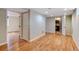 Open basement area with light hardwood flooring and access to a bathroom at 1548 Ulster St, Denver, CO 80220