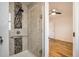 Shower with decorative stone tile, glass door and hand shower at 1548 Ulster St, Denver, CO 80220
