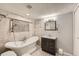 Charming bathroom with soaking tub, pebble accents, and modern vanity at 1548 Ulster St, Denver, CO 80220
