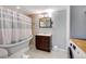 Well-lit bathroom with vintage tub, modern vanity, and new washer/dryer at 1548 Ulster St, Denver, CO 80220