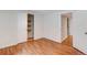 Bedroom with light hardwood floors and closet with shelves in a well-lit home at 1548 Ulster St, Denver, CO 80220