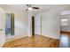 Bright bedroom with hardwood floors, closet, and ceiling fan for comfortable living at 1548 Ulster St, Denver, CO 80220