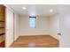 A bedroom with laminate wood flooring and a closet for plenty of storage at 1548 Ulster St, Denver, CO 80220