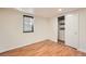 This room features hardwood floors, a window, and a closet, creating a cozy and inviting space at 1548 Ulster St, Denver, CO 80220