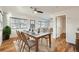 Sunlit dining area with hardwood floors and a table set for dinner, seamlessly flowing into the living room at 1548 Ulster St, Denver, CO 80220
