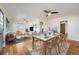 Bright open-concept dining room with hardwood floors and modern ceiling fan and furniture at 1548 Ulster St, Denver, CO 80220
