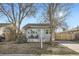 Charming single-story home with a cozy front porch and well-maintained yard at 1548 Ulster St, Denver, CO 80220