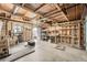 This unfinished garage with exposed wood frame has a concrete floor and workbench at 1548 Ulster St, Denver, CO 80220