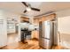 Cozy kitchen with stainless steel appliances, light wood cabinets, and hardwood floors at 1548 Ulster St, Denver, CO 80220