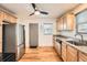 Well-lit kitchen featuring stainless steel appliances and hardwood floors at 1548 Ulster St, Denver, CO 80220