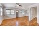 Spacious living area filled with light, featuring refinished hardwood floors at 1548 Ulster St, Denver, CO 80220
