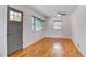 The living room features refinished hardwood floors and lots of natural light at 1548 Ulster St, Denver, CO 80220