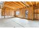 Unfinished basement featuring a door to the outside, concrete floor, and wooden ceiling frame at 1356 Castle Creek Cir, Castle Rock, CO 80104