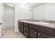 Bathroom with double vanity featuring granite countertops, tile floors, and bath at 1356 Castle Creek Cir, Castle Rock, CO 80104