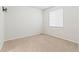 A well-lit bedroom with neutral carpet, a window with blinds, and white walls at 1356 Castle Creek Cir, Castle Rock, CO 80104