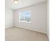 Bright bedroom featuring neutral carpeting, white walls, and neighborhood views at 1356 Castle Creek Cir, Castle Rock, CO 80104
