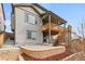 Exterior angle showing outdoor patio with stairs up to a deck and backyard at 1356 Castle Creek Cir, Castle Rock, CO 80104