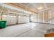 Spacious three car garage with painted drywall, ample parking space, and bright overhead lighting at 1356 Castle Creek Cir, Castle Rock, CO 80104