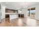 Expansive kitchen boasts dark wood cabinets, granite countertops, and a sliding door to the deck at 1356 Castle Creek Cir, Castle Rock, CO 80104