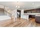 Open-concept kitchen showcases stainless steel appliances, dark wood cabinets, and an island at 1356 Castle Creek Cir, Castle Rock, CO 80104