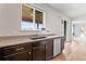 Stylish kitchen featuring granite countertops, a stainless steel dishwasher, and a sink at 1356 Castle Creek Cir, Castle Rock, CO 80104