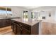 Open concept kitchen featuring granite countertops, a large island, and stainless steel appliances at 1356 Castle Creek Cir, Castle Rock, CO 80104