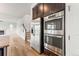 Modern kitchen with stainless steel appliances including refrigerator, oven, and hardwood floors at 1356 Castle Creek Cir, Castle Rock, CO 80104